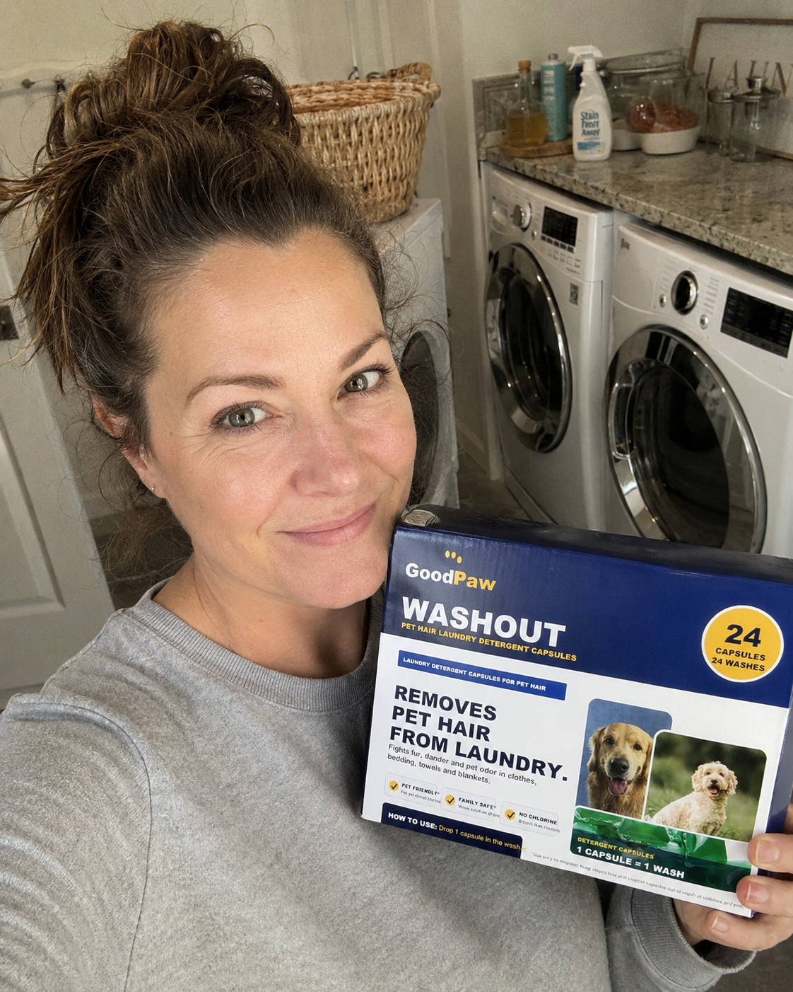 Megan holding GoodPaw WashOut in her laundry room